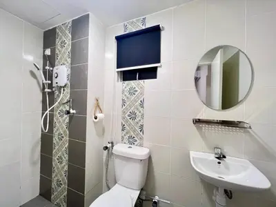 a bathroom with a toilet and a sink and a mirror at Stay at Anderson Condo1615 Ipoh Town in Ipoh
