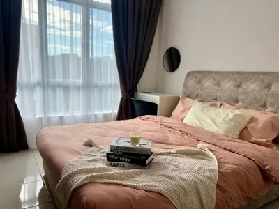 a bed with a pile of books on it at Stay at Anderson Condo1615 Ipoh Town in Ipoh
