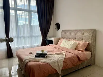 a bedroom with a bed with pink sheets and a window at Stay at Anderson Condo1615 Ipoh Town in Ipoh