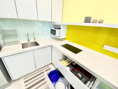a kitchen with white cabinets and a sink and a refrigerator at Straits Garden Suites #Pool with view #Seaview and bridge view #Georgetown #3pax #2BR2bath #1Queen 1Single #Quality well maintained #Private host in George Town
