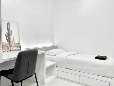 a bedroom with a desk and a bed and a chair at Straits Garden Suites #Pool with view #Seaview and bridge view #Georgetown #3pax #2BR2bath #1Queen 1Single #Quality well maintained #Private host in George Town