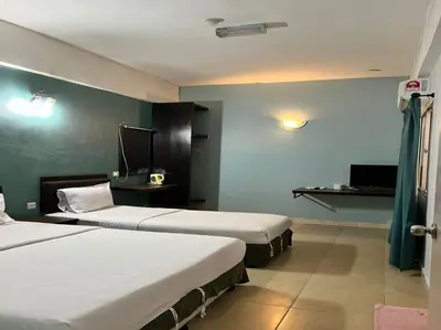 a hotel room with two beds and a television at Dancenter Near Shell Jalan Iskandar Shah, Orchard in Kampong Tebing Rabak