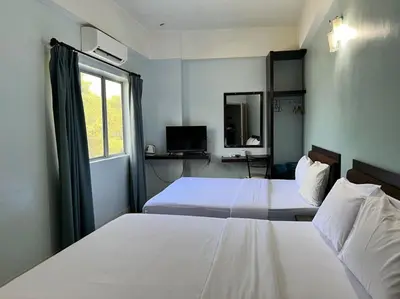 a hotel room with two beds and a window at Dancenter Near Shell Jalan Iskandar Shah, Orchard in Kampong Tebing Rabak