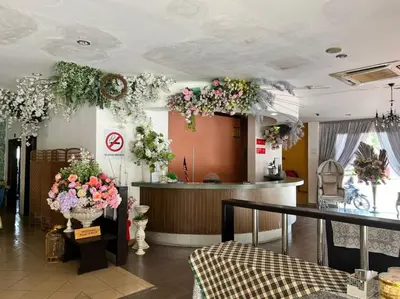 a lobby with flowers on the walls and a counter at Dancenter Near Shell Jalan Iskandar Shah, Orchard in Kampong Tebing Rabak