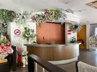 a lobby with a bar with flowers on the wall at Dancenter Near Shell Jalan Iskandar Shah, Orchard in Kampong Tebing Rabak