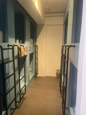 a room with three bunk beds and a door at \u5343\u5c9b\u7f8e\u4eba\u9c7c\u9152\u5e97 in Gua Sai