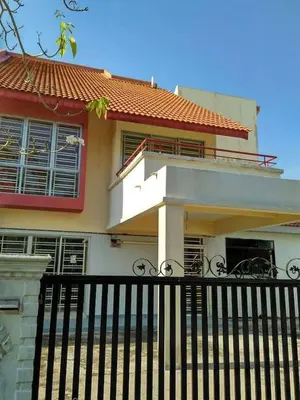 a house with a black fence in front of it at Batu Kawan HS in Simpang Ampat