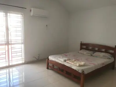 a bedroom with a bed in a room with a window at Batu Kawan HS in Simpang Ampat