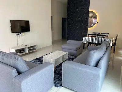 a living room with two couches and a tv at RB Homestay Modern Comfort in Hutan Melintang