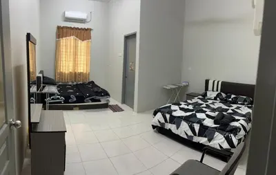 a bedroom with two beds and a mirror in it at RB Homestay Modern Comfort in Hutan Melintang