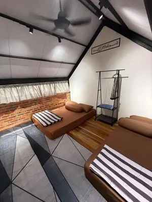 a bedroom with two beds in a room at Kurie Redbrick House in Balik Pulau