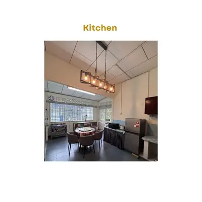 a kitchen with a table and chairs in a room at Homestay The White House Balik Pulau Penang in Balik Pulau