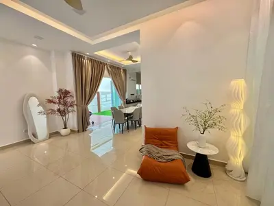 a living room with an orange couch and a table at Heartstay Tanjong Karang \u598d\u83c1\u540d\u5bbf in Kampong Tanjong Karang
