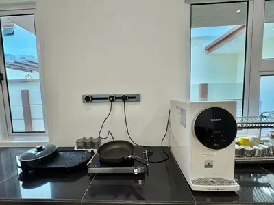 a kitchen with a pan on top of a counter at Heartstay Tanjong Karang \u598d\u83c1\u540d\u5bbf in Kampong Tanjong Karang