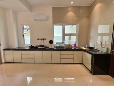 a kitchen with a black counter top and some windows at Heartstay Tanjong Karang \u598d\u83c1\u540d\u5bbf in Kampong Tanjong Karang