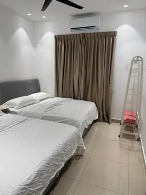 two beds in a room with a ladder next to a window at Heartstay Tanjong Karang \u598d\u83c1\u540d\u5bbf in Kampong Tanjong Karang