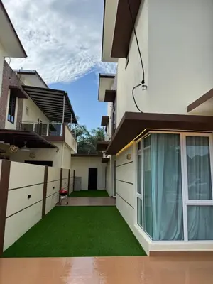 a view of a house with a green yard at Heartstay Tanjong Karang \u598d\u83c1\u540d\u5bbf in Kampong Tanjong Karang