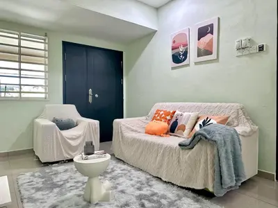 a bedroom with a bed and a chair in it at Specious Living Cozy House in Bukit Mertajam