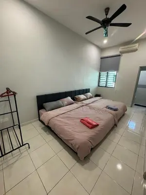 a large bed in a bedroom with a ceiling fan at 16 pax HB Homestay Raja Uda Ong Yi How Butterworth - Budget Homestay - KTV NETFLIX MAHJONG in Butterworth