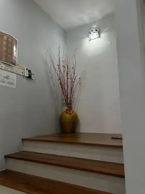 a vase on a shelf with a plant in it at Seri Hayzar Homestay in Gua Sai