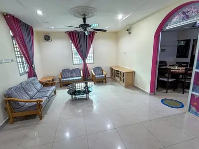 a living room with a couch and a table at M S Villa Homestay Ayer Tawar in Ayer Tawar