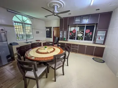 a kitchen and dining room with a table and chairs at M S Villa Homestay Ayer Tawar in Ayer Tawar