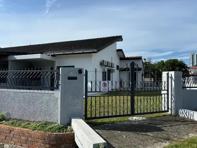 a fence in front of a white house at Rumah Bonda in Gua Sai