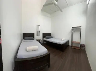 a room with two beds and a couch in it at Rumah Bonda in Gua Sai