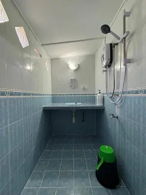 a bathroom with a sink and a shower in it at Rumah Bonda in Gua Sai