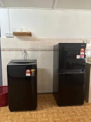 a kitchen with a black refrigerator in a room at Rumah Bonda in Gua Sai