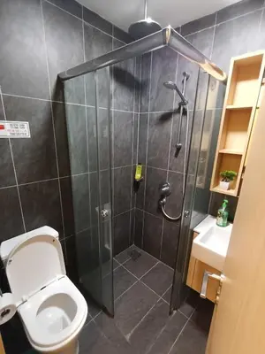 a bathroom with a shower and a toilet at Infinitum suites at colony KLCC in Gua Sai