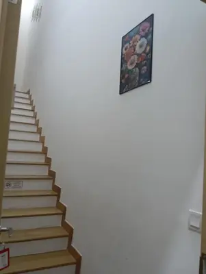 a stairway with a picture on the wall at Infinitum suites at colony KLCC in Gua Sai