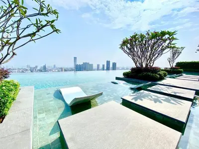 a pool with benches and a view of the city at Beacon Executive Suite Penang George Town in George Town