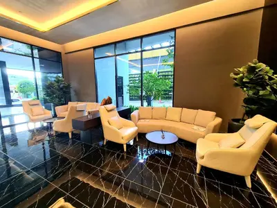 a lobby with couches and chairs and windows at Beacon Executive Suite Penang George Town in George Town