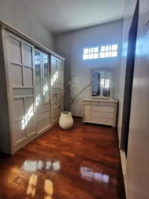 a living room with a dresser and a mirror at Ryui's Quiet Bungalow - Room Only - No Extra Tax in Sungai Petani