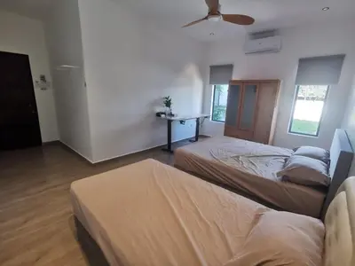 a bedroom with two beds and a ceiling fan at Ryui's Quiet Bungalow - Room Only - No Extra Tax in Sungai Petani