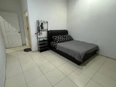 a bedroom with a bed and a tiled floor at Ummu Homestay 03 in Batu Gajah