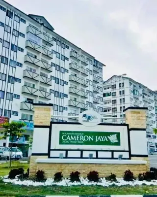 a large building with a sign in front of it at Golden Bright Future Trading in Tanah Rata