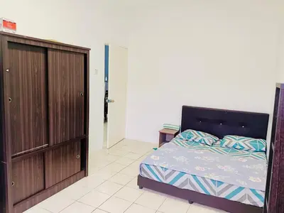 a bedroom with a bed and a wooden cabinet at Golden Bright Future Trading in Tanah Rata