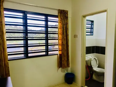 a bathroom with a toilet and a large window at Golden Bright Future Trading in Tanah Rata