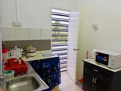 a small kitchen with a sink and a microwave at Golden Bright Future Trading in Tanah Rata