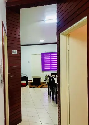 an open door to a dining room with a purple window at Golden Bright Future Trading in Tanah Rata
