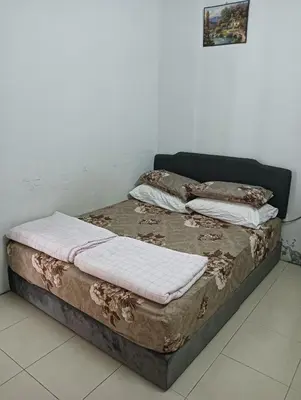 a bed with two pillows on it in a room at Taman yu sungai besar in Sungai Besar