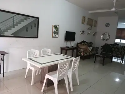 a white table and chairs in a living room at Taman yu sungai besar in Sungai Besar