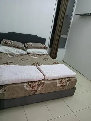 a bed sitting on top of a floor in a room at Taman yu sungai besar in Sungai Besar