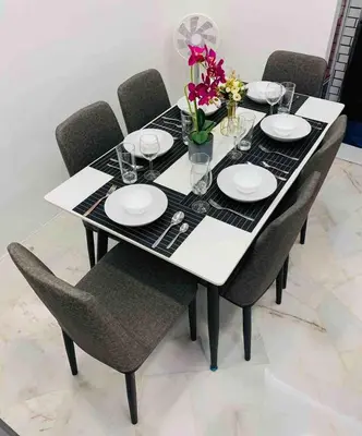 a black and white table with chairs and plates and flowers at Love birds Abbie's Private Pool Villa 2 pax in Bukit Mertajam