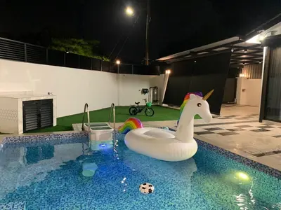 a pool with a toy unicorn in a swimming pool at Love birds Abbie's Private Pool Villa 2 pax in Bukit Mertajam
