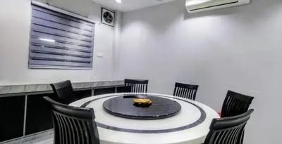 a dining room with a table and chairs at 18pax Bungalow Homestay Hutan Melintang in Hutan Melintang
