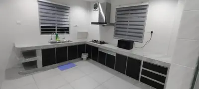a white kitchen with a sink and two windows at 18pax Bungalow Homestay Hutan Melintang in Hutan Melintang
