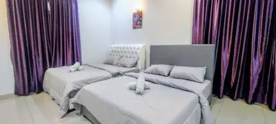 two beds in a room with purple curtains at 18pax Bungalow Homestay Hutan Melintang in Hutan Melintang